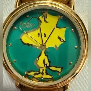 Vintage Armitron Woodstock Watch with green background and yellow Woodstock.